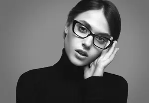 black and white portrait of a woman with glasses