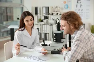 Man getting eye exam from female optometrist