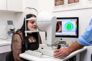 woman in a medical clinic having her eyes checked with a machine