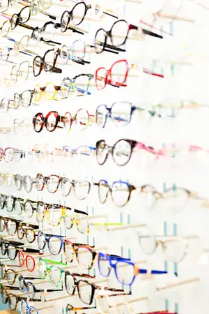 A wall display of various colored glasses in a store.