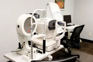 An ophthalmic diagnostic device on a white table in a room