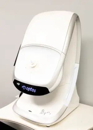 A white machine with a blue Optos logo on a white surface.