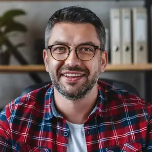 Business man in a plaid shirt smiling for the camera