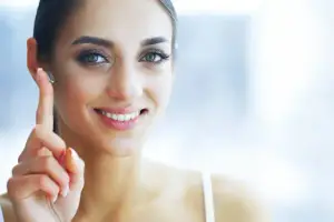 Close-up of a woman wearing earrings and smiling