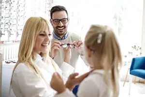 A happy family choosing their eyewear at 20/20 Eye Care in Alpharetta, GA.