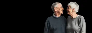 Senior couple standing next to each other smiling