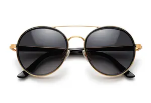 Gold-framed sunglasses with black lenses displayed against a white background
