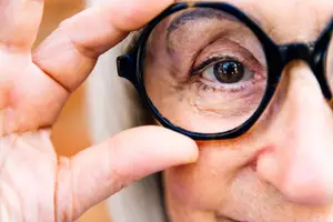 Senior woman adjusting her glasses to improve her vision