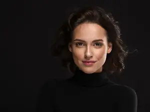 woman wearing contacts on black background