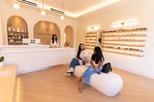 Optometrist at front desk ready to assist patients at Maison De Vision Eye Care Studio