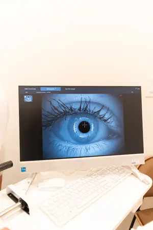 Diagnostic ophthalmic equipment in use with image of an eye displayed