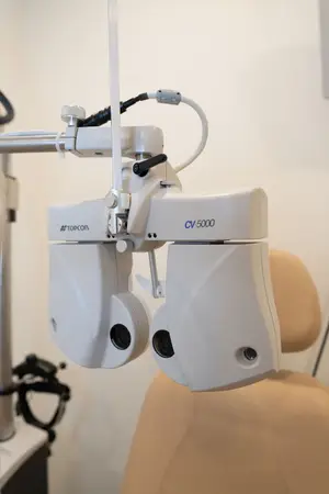 A white Topcon CV-5000 ophthalmoscope machine in a medical setting.