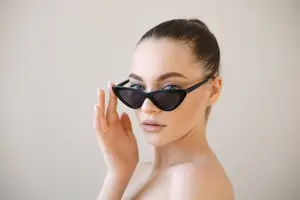 Woman adjusting sunglasses