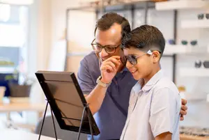 father and son shopping for new eyeglasses and sunglasses