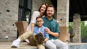 A family on the porch of their house.