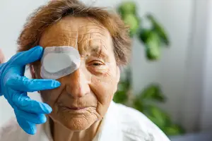 Elderly woman wearing a bandage on her eye