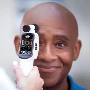 A man with a device measuring his intraocular pressure for glaucoma detection