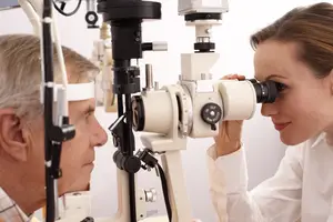 Senior man having his eyes examined by an optometrist
