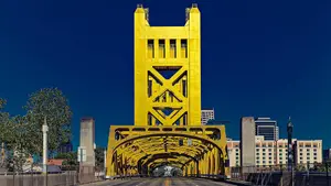 The Golden Gate Bridge in San Francisco is painted yellow with a blue sky in the background.