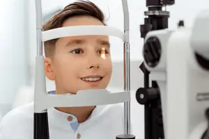 A young boy getting his eyes examined by a doctor