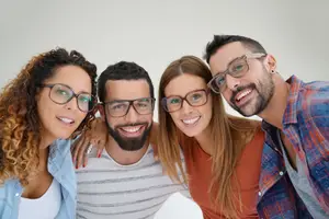 A group of four people wearing glasses and smiling for a photo