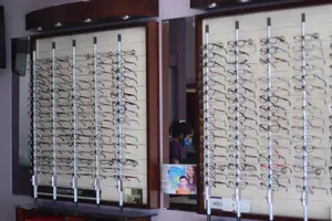 A store full of glasses for sale with a mirror in the background.