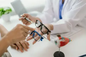Doctor showing patient a pair of glasses