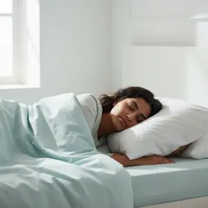 A woman sleeps peacefully in a neatly made bed with white linens and pillows, bathed in soft natural light from a nearby window.
