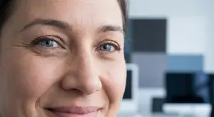 Close up of woman's face with crow's feet around the eyes