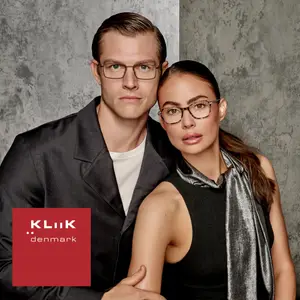 A man and a woman are posing for a photo while wearing glasses.