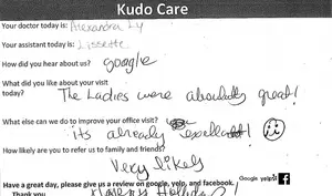 A handwritten note with positive feedback about a visit to a medical office, asking for a review on various platforms.