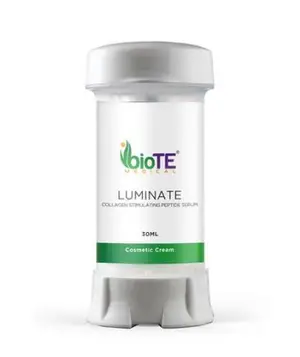 A white bottle with a silver lid and green accent containing Luminate Collagen Stimulating Peptide Serum.