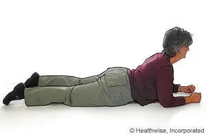 A woman lying on the floor in a stretching pose