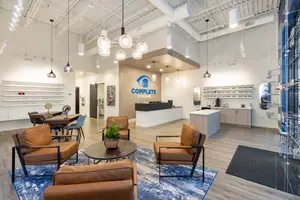 Interior of a Complete Eyecare office with modern furniture and a reception desk.