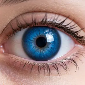 Close-up of a person's eye with blue iris and eyelashes