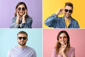 Four people wearing sunglasses posing for the camera in different colors
