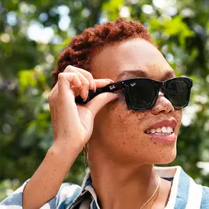woman adjusting sunglasses