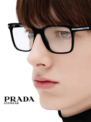 Close up of a person wearing Prada eyewear.
