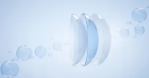 Three contact lenses floating in water with bubbles