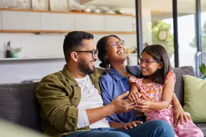 A happy family sitting on a couch in a living room