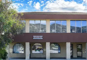The exterior of a building with large windows and a sign reading 'Topa Topa Optometry'