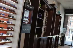 Sunglasses on wooden brown shelves beautifully arranged