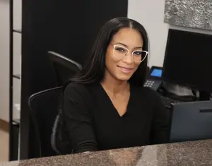 woman wearing white frame eyeglass smiling at the camera