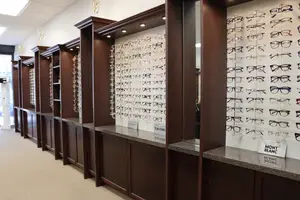 Brown shelves displaying different eyeglasses neatly arranged
