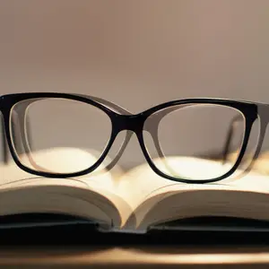 Black glasses on an open book