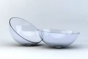 Two transparent glass bowls stacked on top of each other with reflections visible