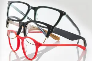 A collection of three glasses frames displayed on a white background, showcasing different colors and styles
