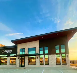 Exterior of a Lumen Eyecare building with a clear sky in the background
