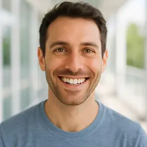Close-up of a man smiling with a bright background