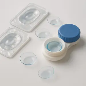 Close up of a lens case and a lens case with contact lenses on a white surface.